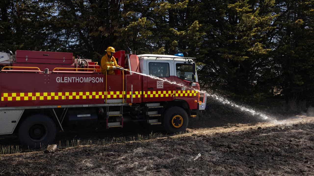 Firefighters conduct back burning on the outskirts of Dunkeld.