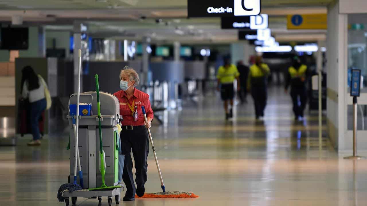 A cleaner works at Sydney International Airport