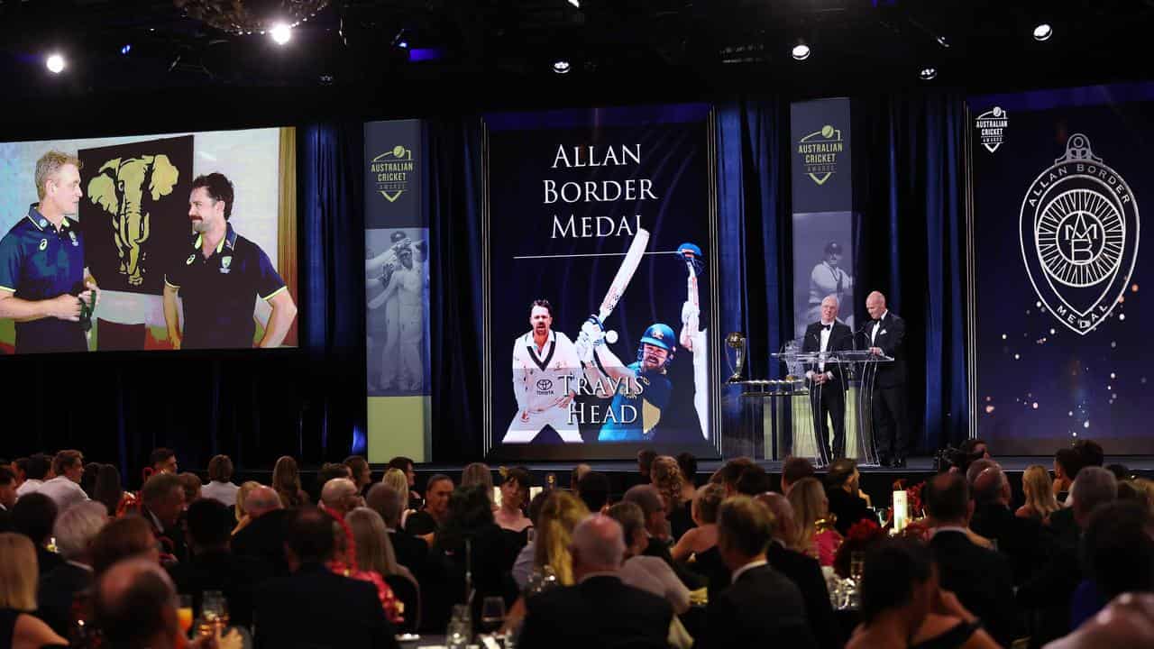 Travis Head accepts his award.