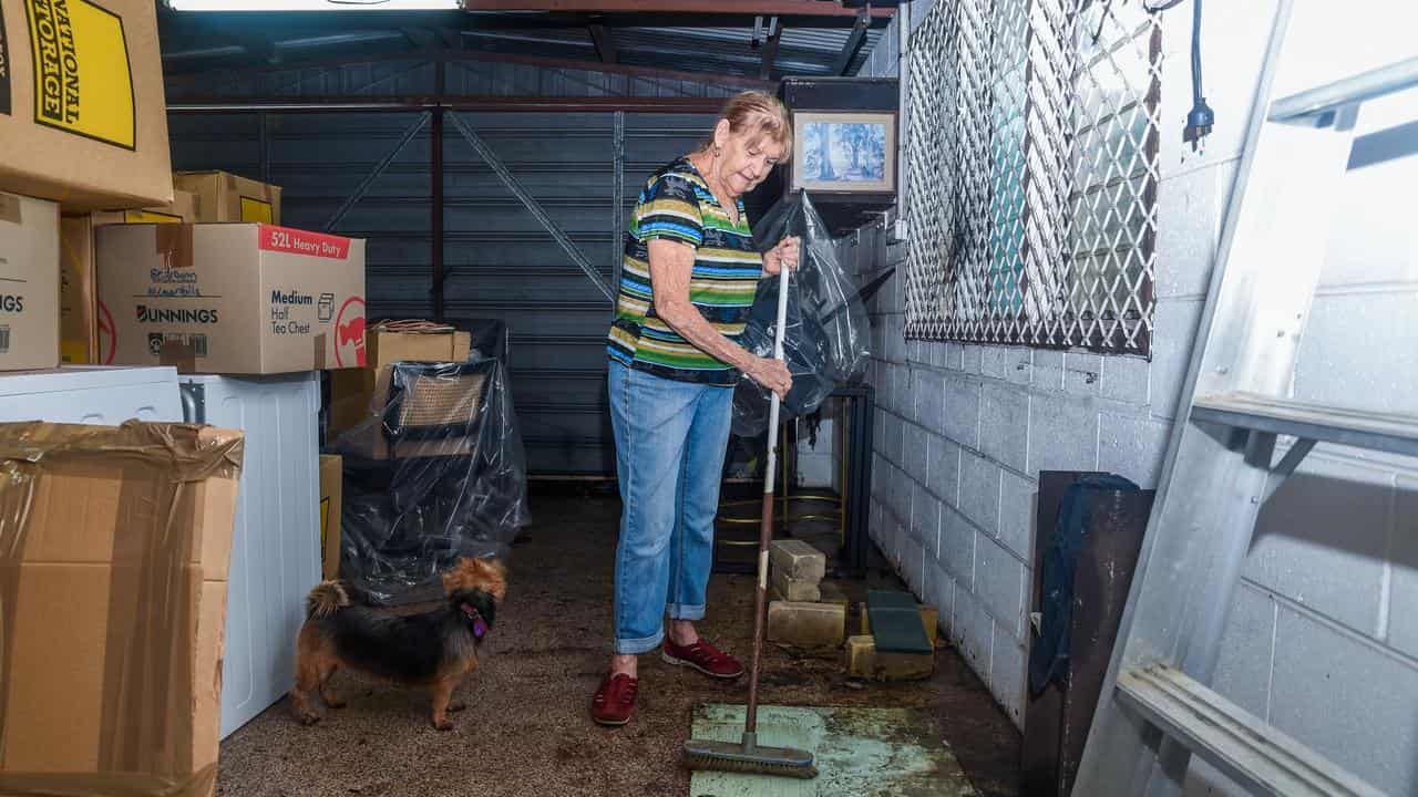 Townsville resident Judi Hinspeter clearing up after heavy rainfall