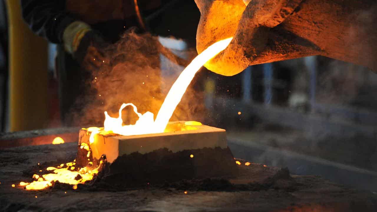 A factory worker pours molten iron (file image)