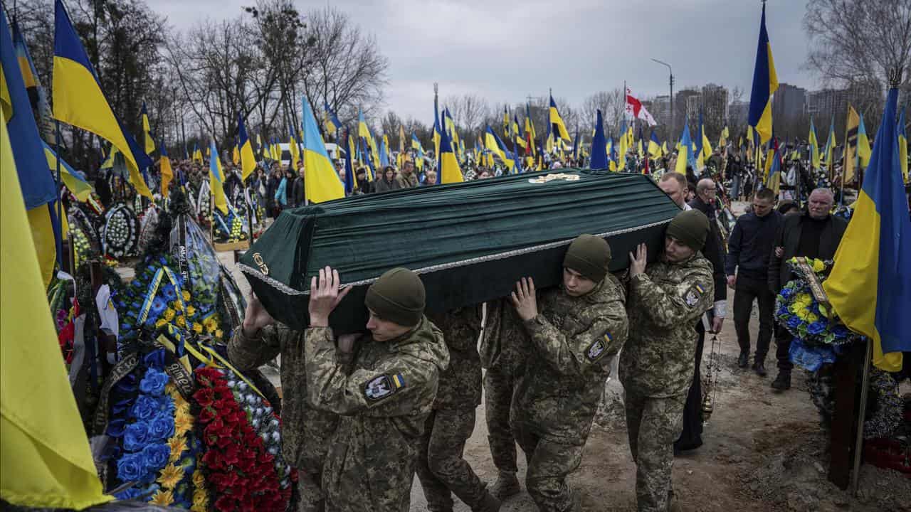 Ukrainian troops carry the coffin of Andrii Neshodovskiy