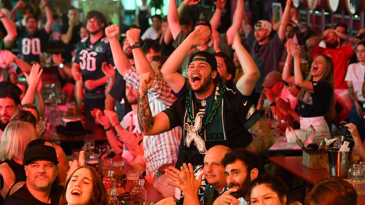 Fans react as they watch the Super Bowl on TV