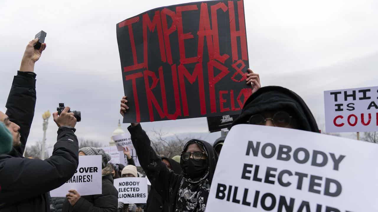 People protest against Elon Musk outside the US Department of Labor