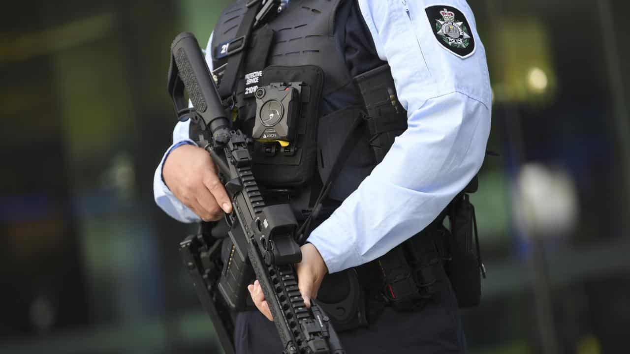 An Australian Federal Police (AFP) officer holds a MK18 rifle