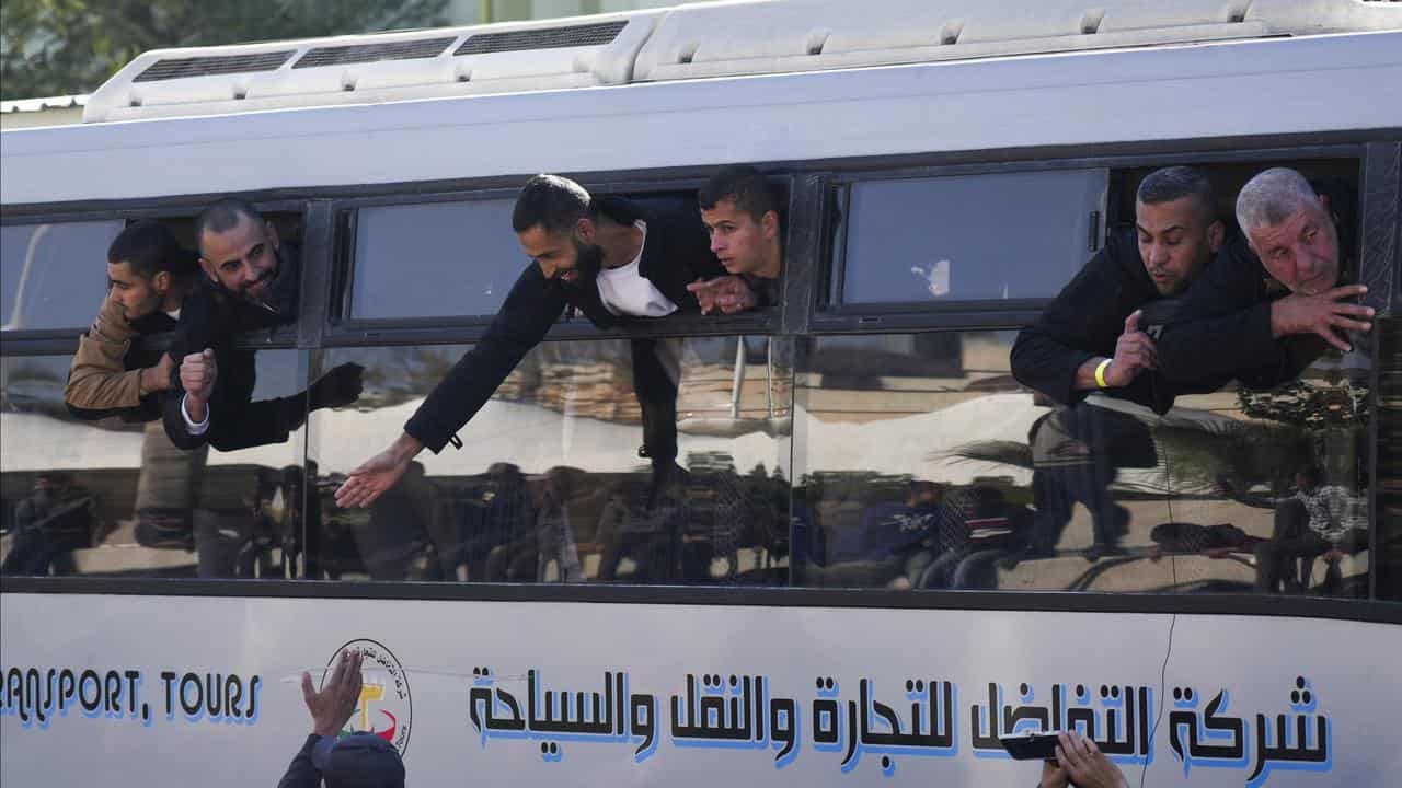 Palestinian prisoners are greeted by a crowd as they arrive in Gaza