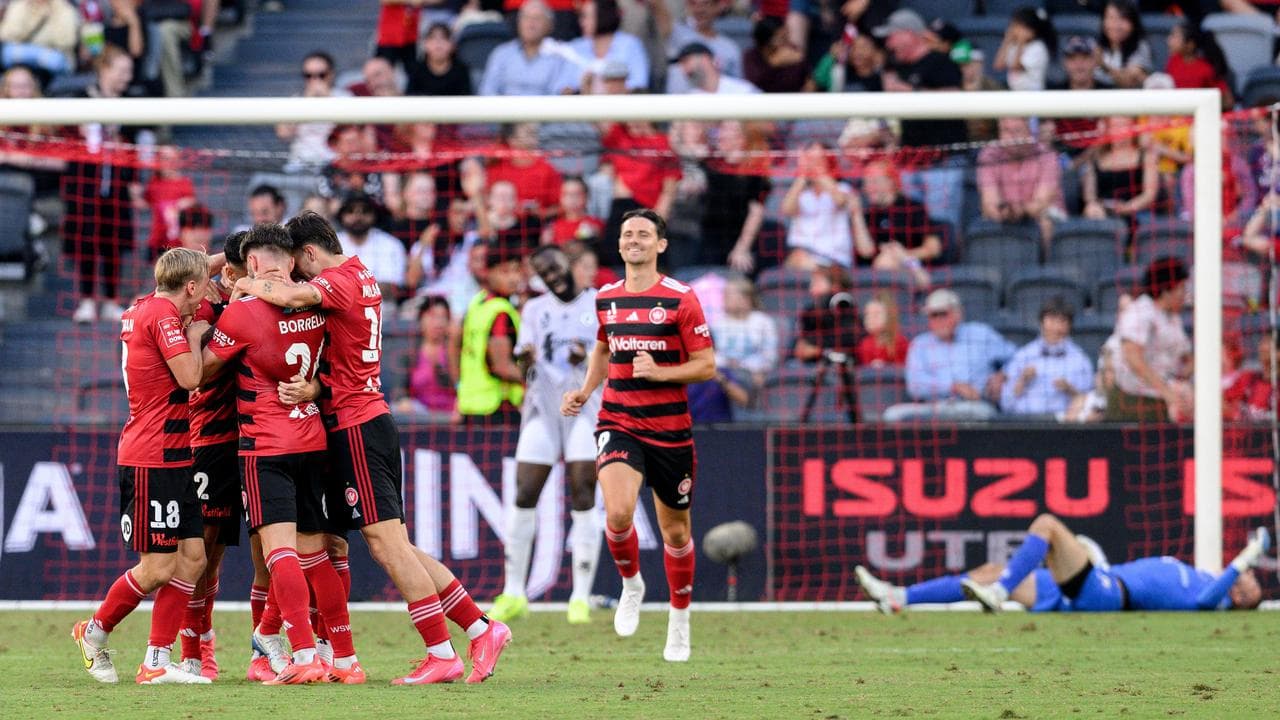 Filip Kurto (right) lies on the ground as Wanderers celebrate.