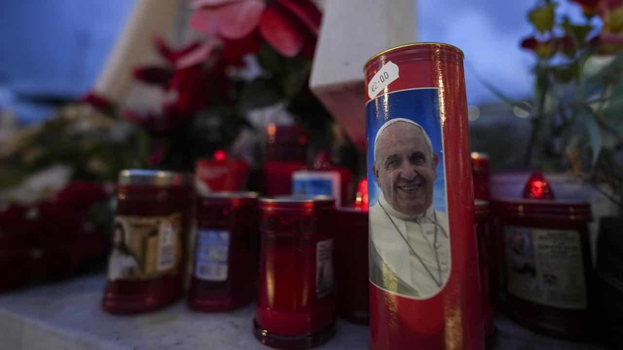 Candles lie in front of the Agostino Gemelli Polyclinic in Rome