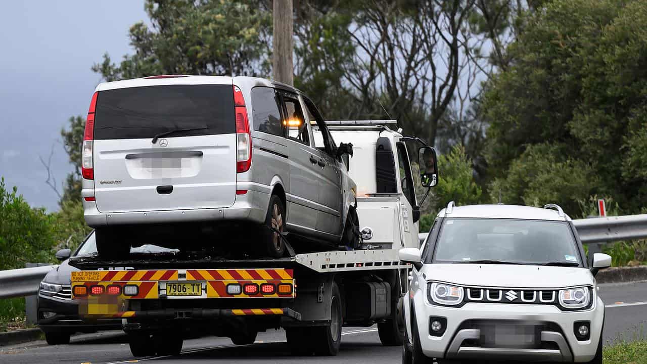 A burnt out car is towed from the scene in Dover Heights