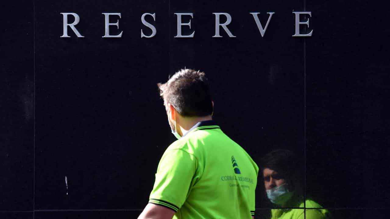 Worker walks past the Reserve Bank of Australia head office