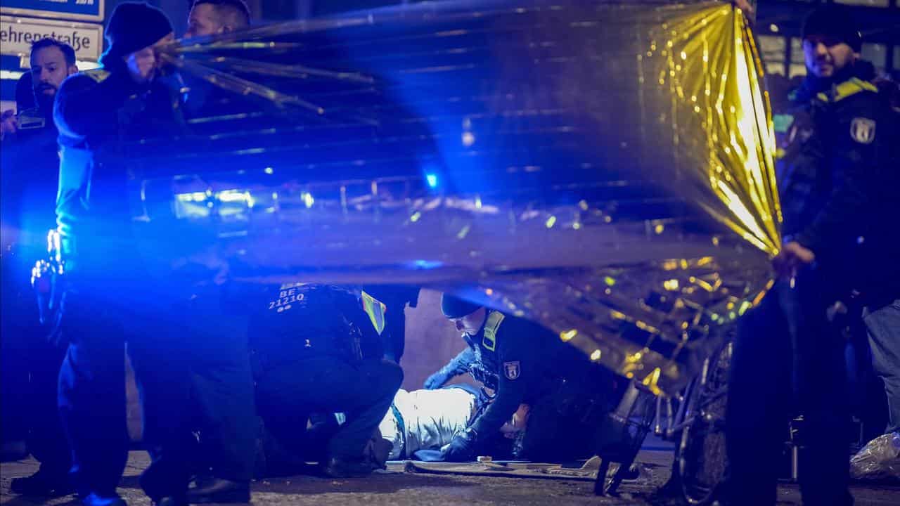 Police detain a man at the Holocaust memorial in Berlin, Germany,