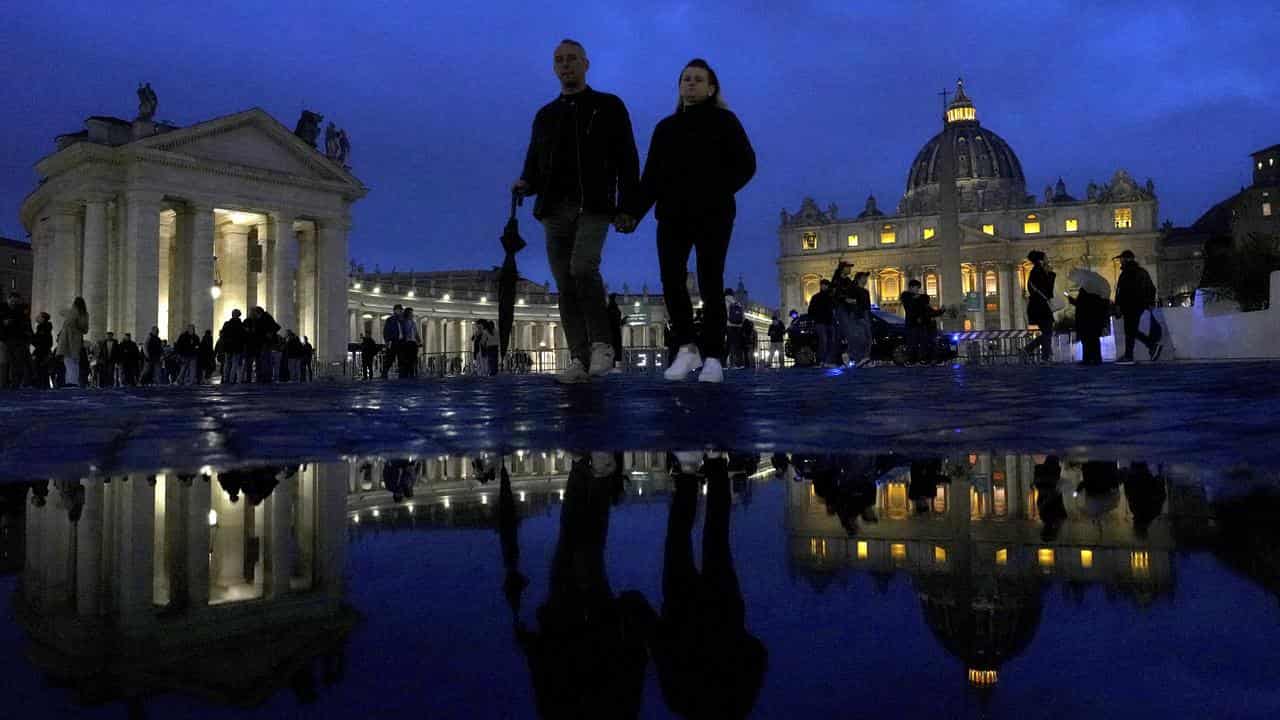 People walk outside St Peter's Square at the Vatican