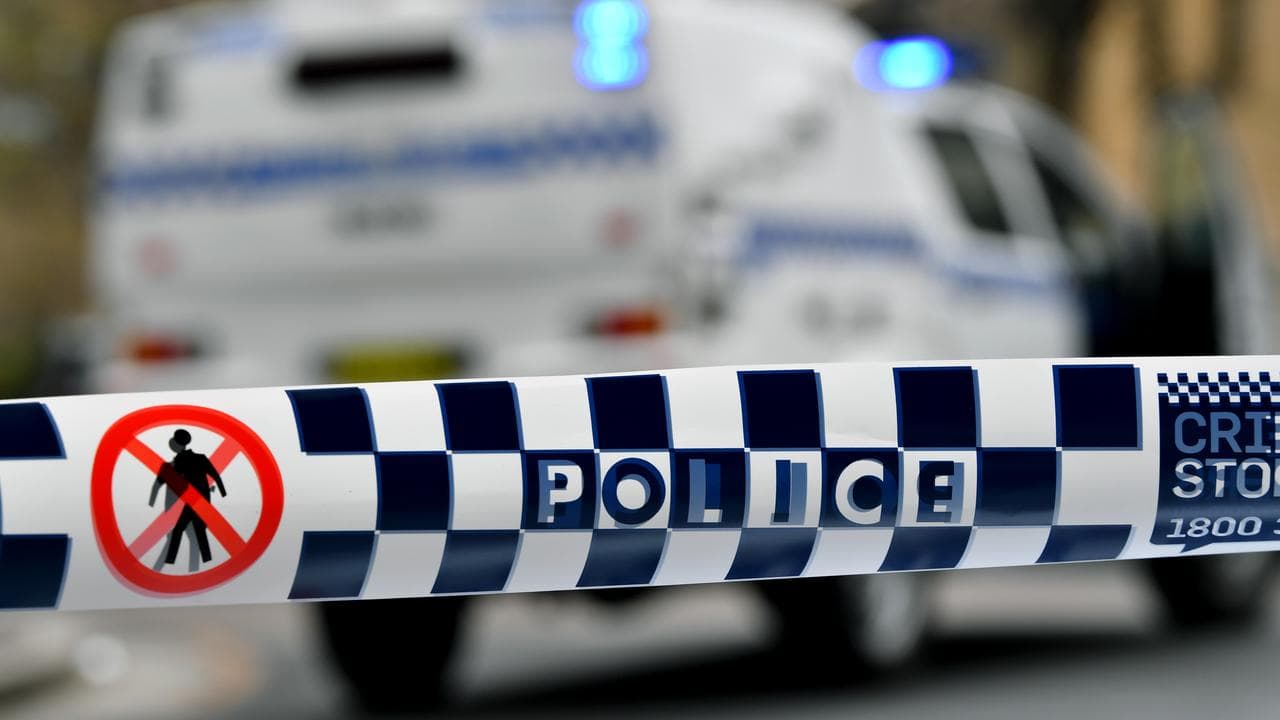 Police tape restricts access to a street