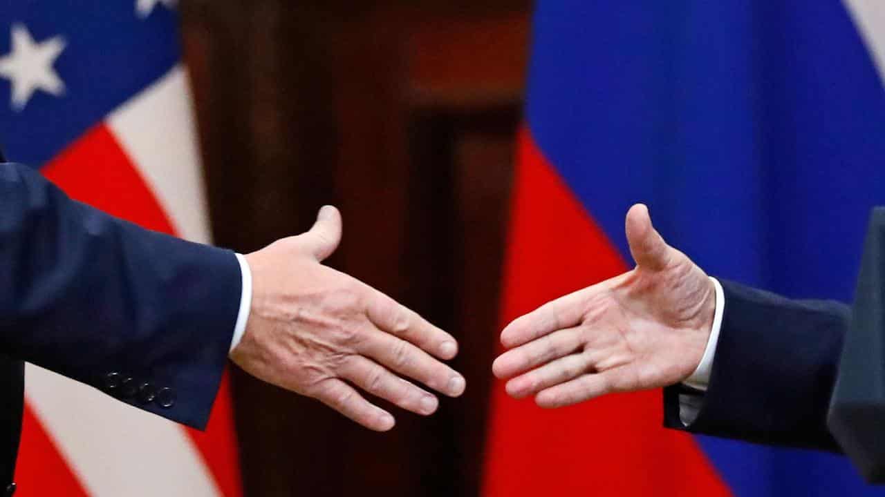 Donald Trump shakes hands with Vladimir Putin (file image)