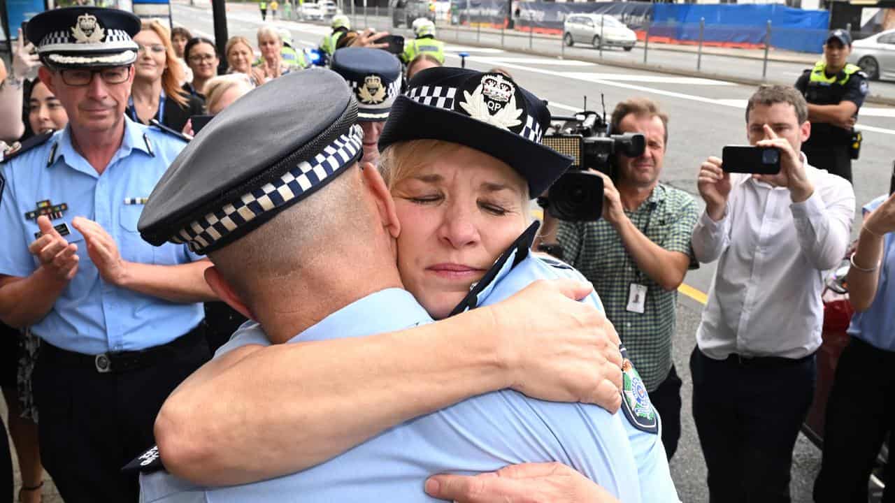 Katarina Carroll hugs Deputy police commissioner Steve Gollschewski