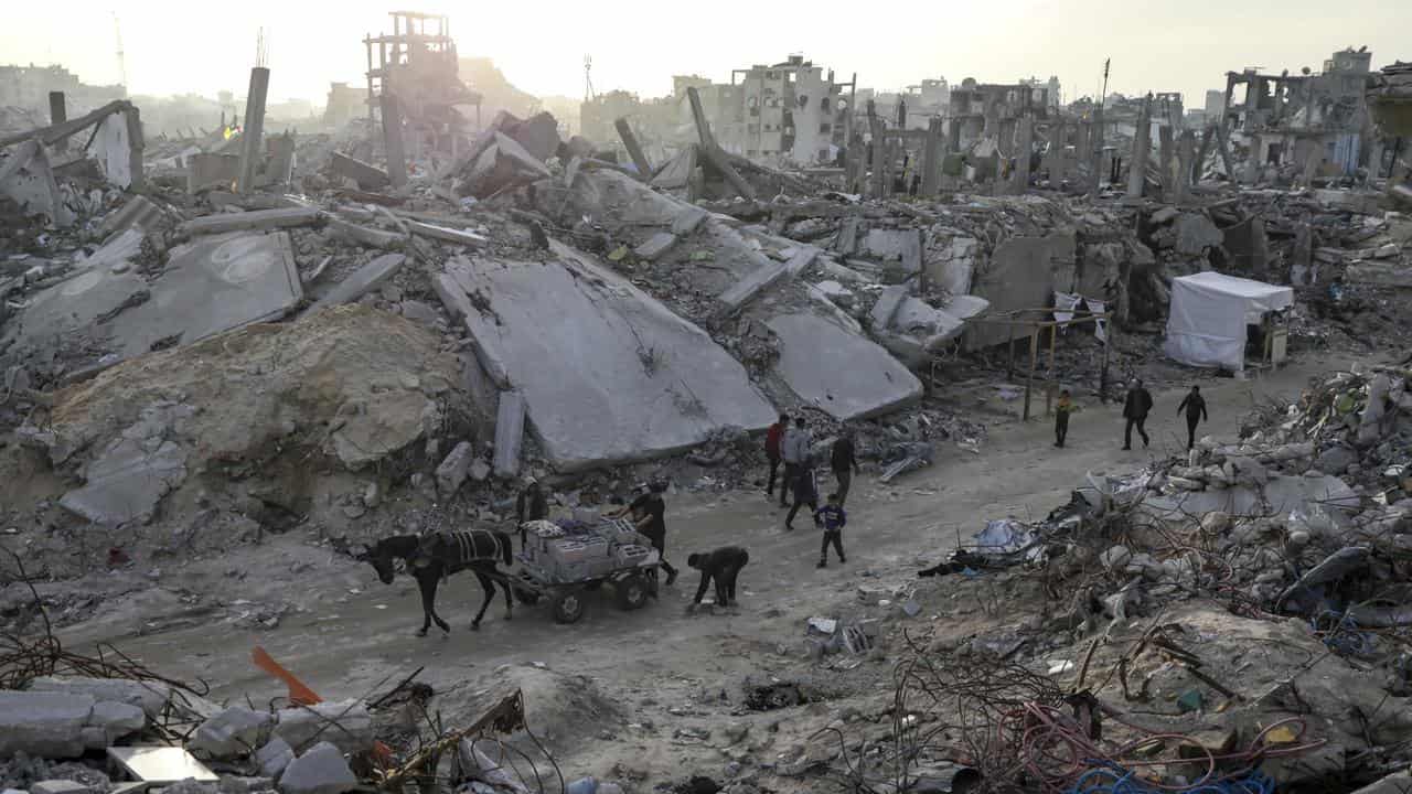 People walk amid the destruction caused in the Gaza Strip (file image)