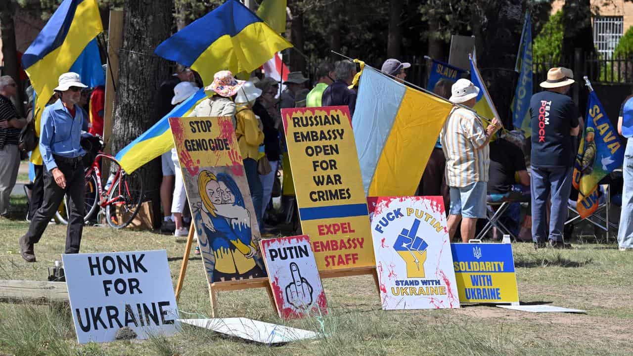 Protesters wave Ukrainian flags and banners