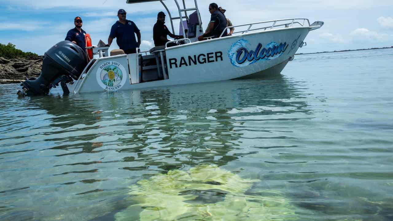 Rangers look at the damage on A reef off One Arm Point