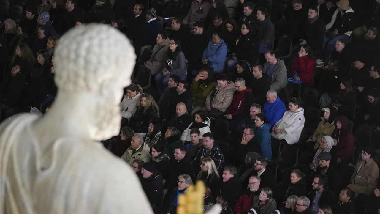 People attend a rosary prayer in St Peter's Square