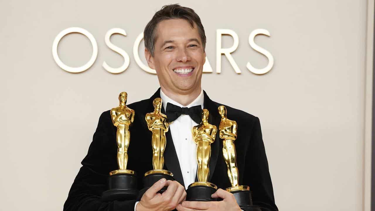 Anora director with his four Oscars