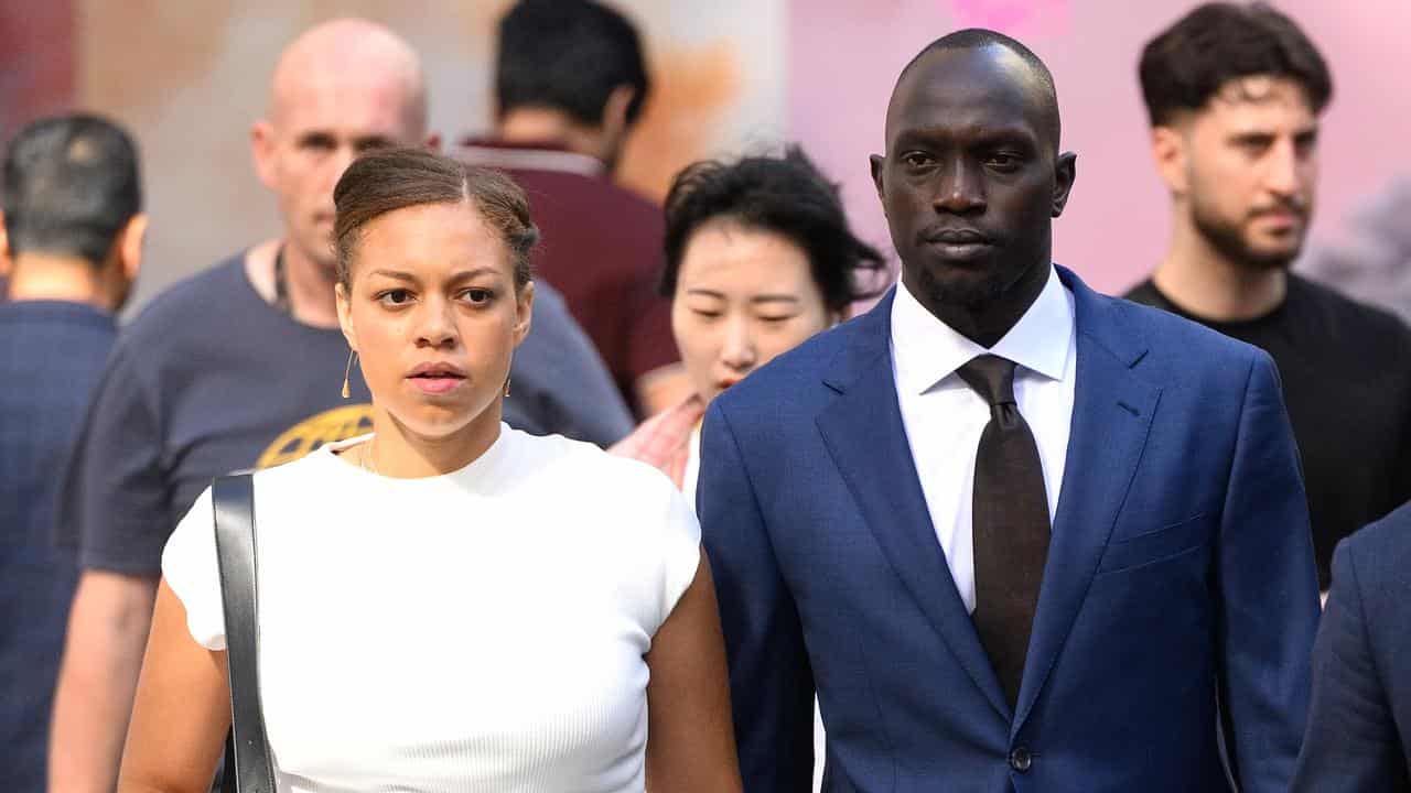 Ruon Tongyik (right) arrives at the Downing Centre District Court