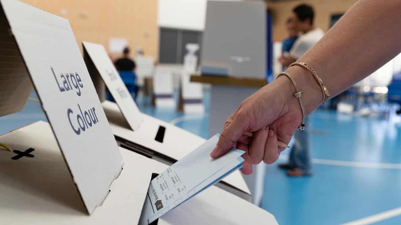 A member of the public casts their vote at a polling station in Perth