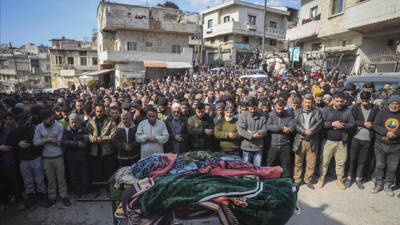 Villagers pray at the funeral of four Syrian security force members