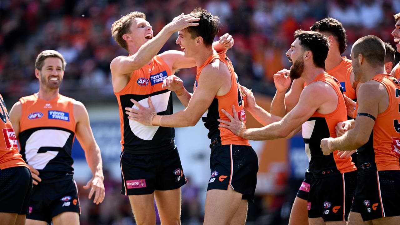 Giants teammates congratulate Sam Taylor (centre)