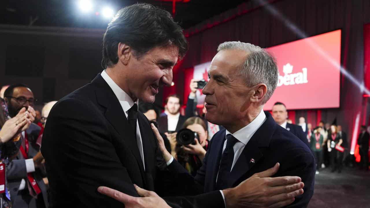 Mark Carney, right, speaks to Canadian Prime Minister Justin Trudeau