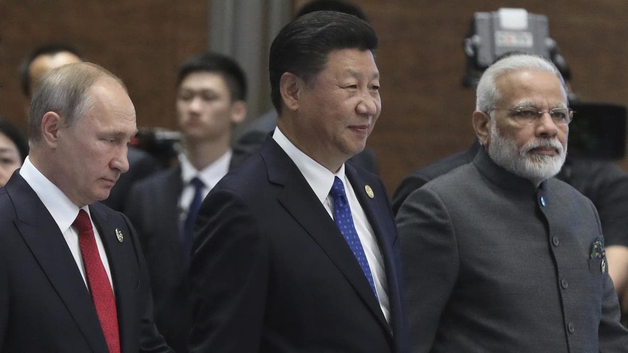 Vladimir Putin, left, Xi Jinping, center, and Narendra Modi