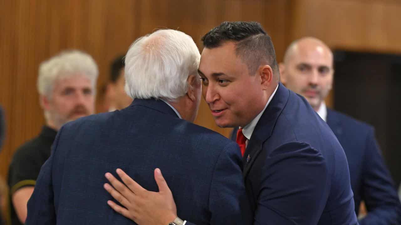 Senator Ralph Babet hugs Trumpet of Patriots spokesman Clive Palmer