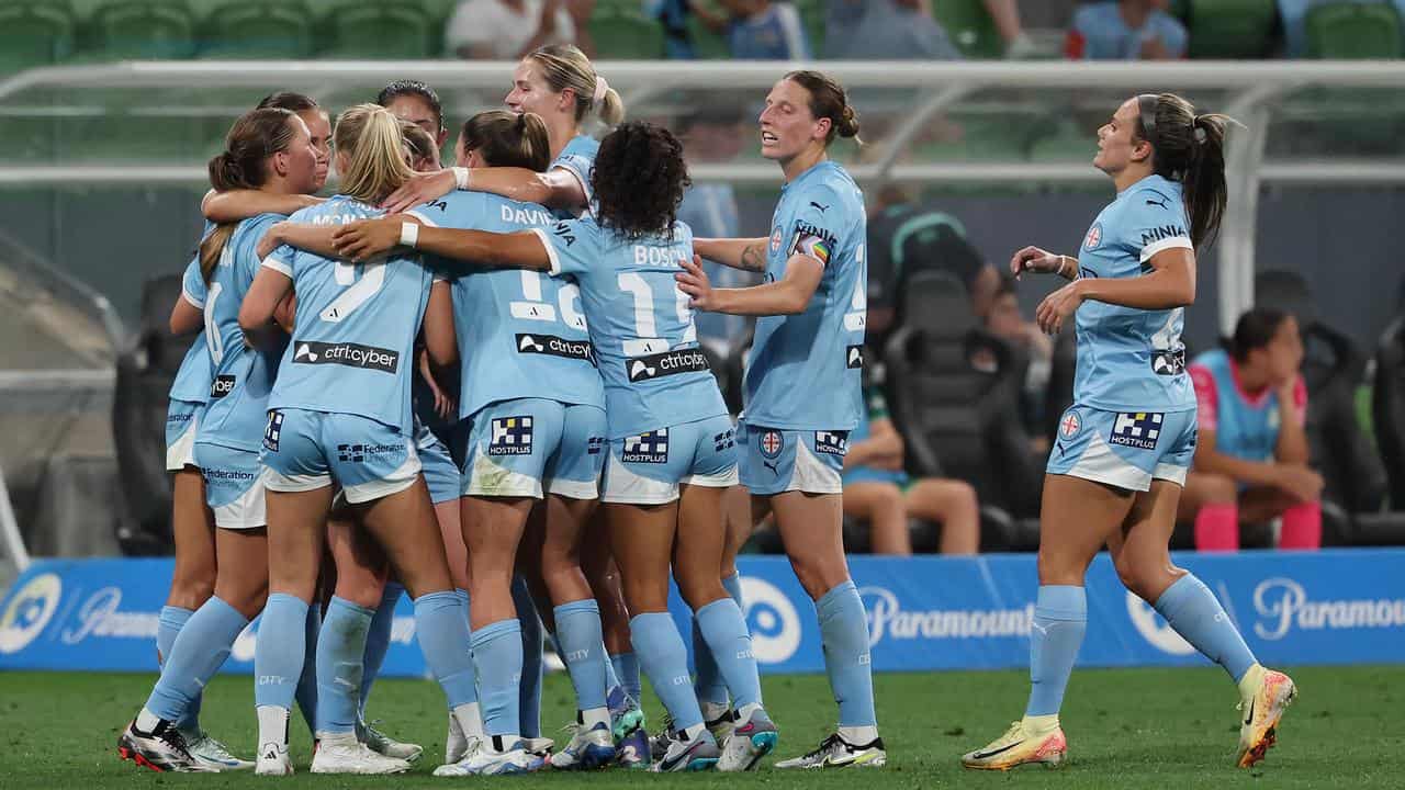 City players celebrate a goal.