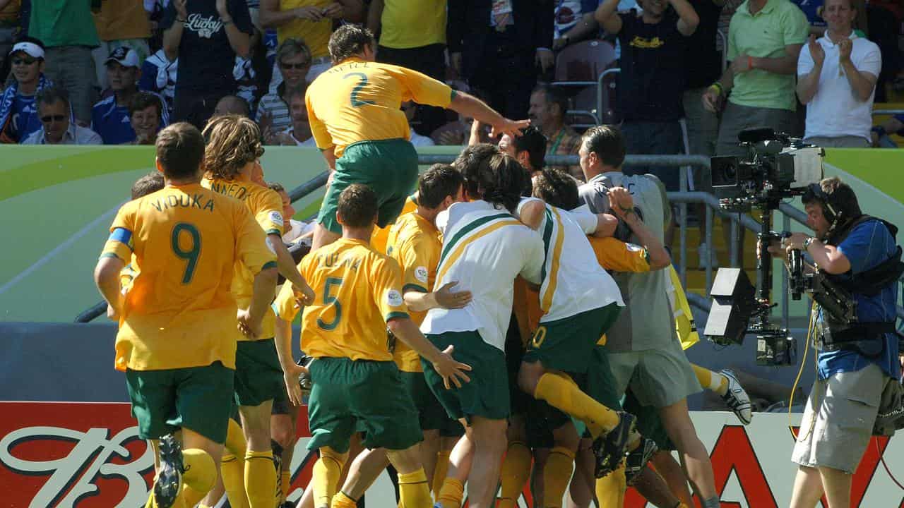 The Australian team celebrates after Tim Cahill scores