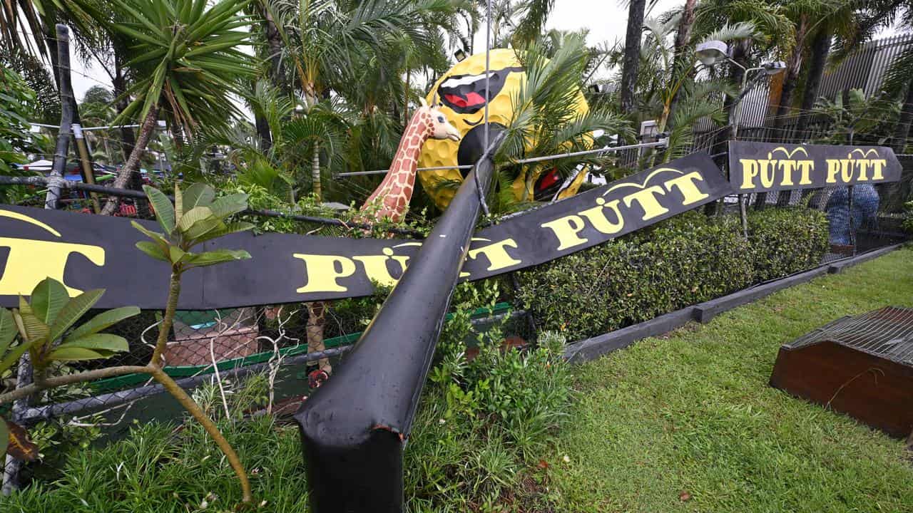 Giant golf ball sign is seen fallen at Mermaid Beach on the Gold Coast