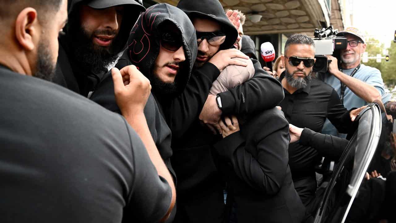 Sarah Abu Lebdeh (centre) is protected by supporters