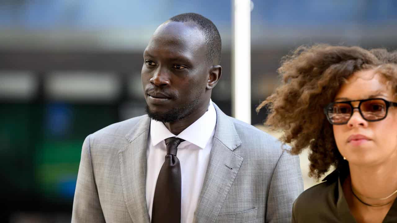 Ruon Tongyik (left) arrives at the Downing Centre District Court