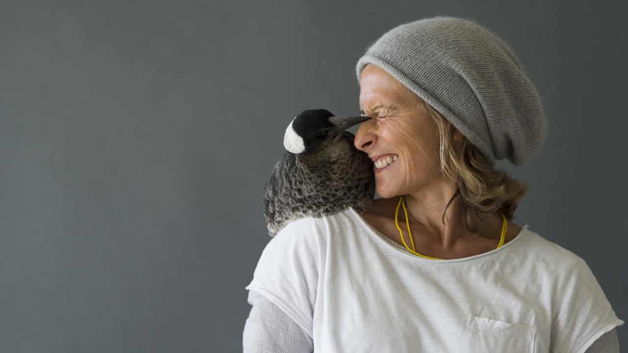 Sam Bloom with Penguin the magpie