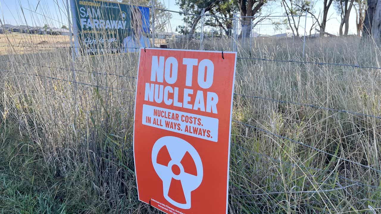 An anti-nuclear sign near an election poster for a Nationals candidate