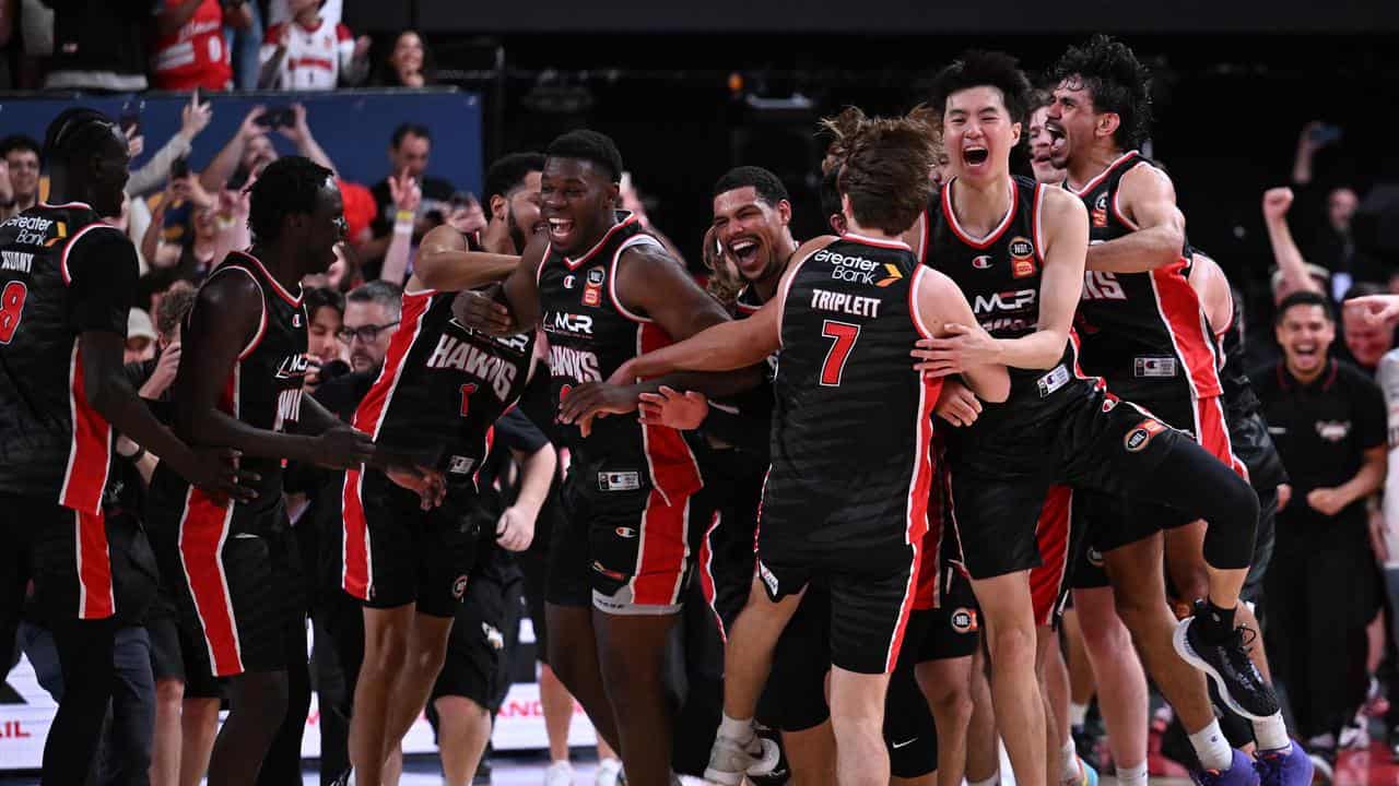 The Hawks celebrate their win over United