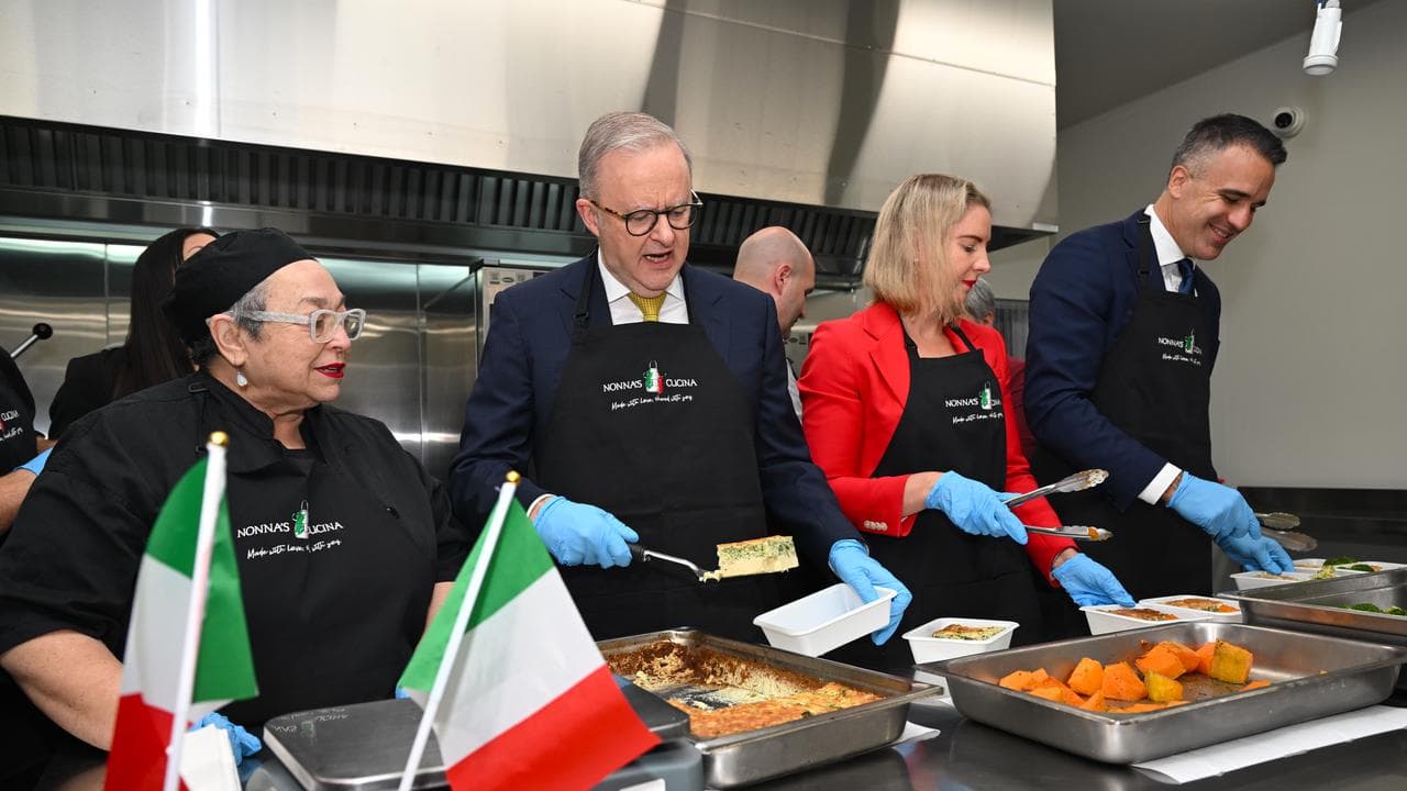 Anthony Albanese helps serve food