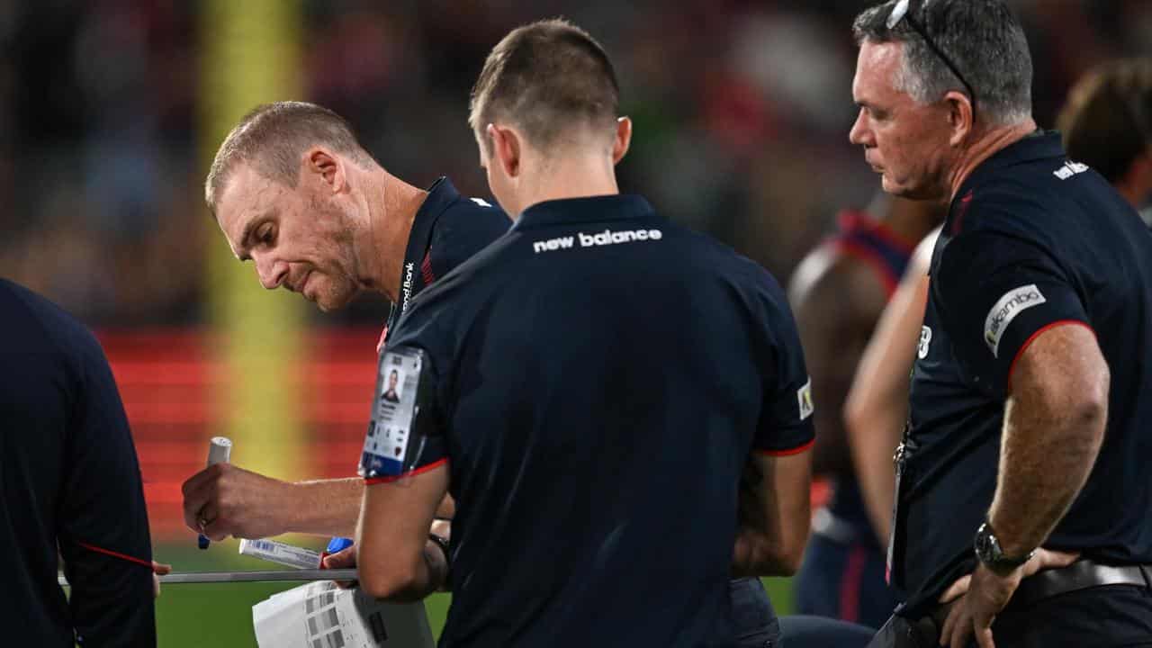 Melbourne coach Simon Goodwin (left)