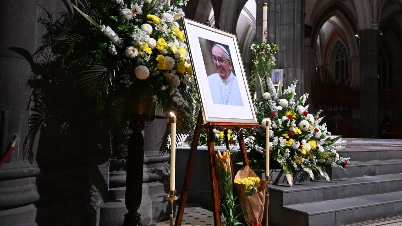 Flowers near a picture of Pope Francis