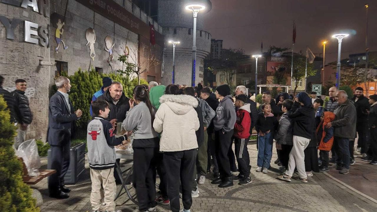 People collect food at a distribution point in Istanbul, Turkey
