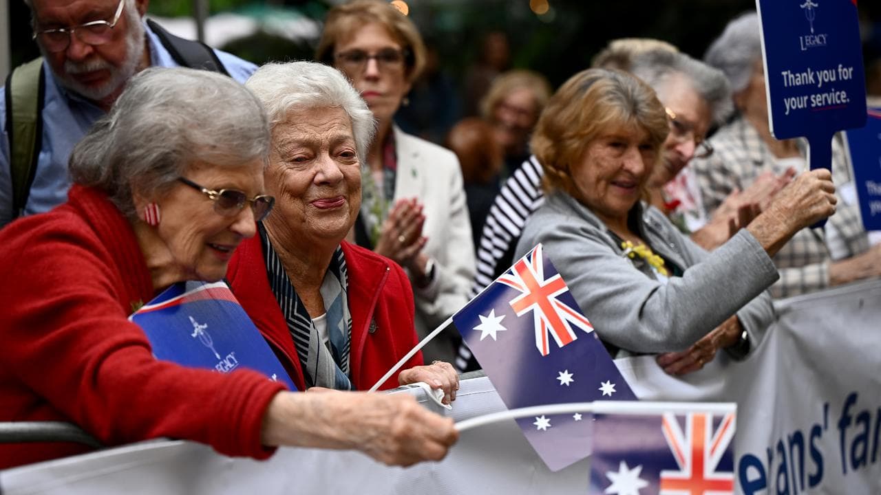 Women watch the Anzac Day March in Sydney