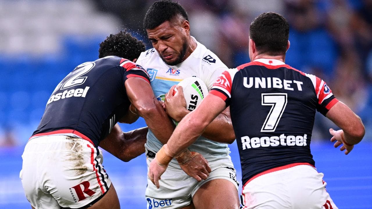 The Titans' Moeaki Fotuaika (centre)