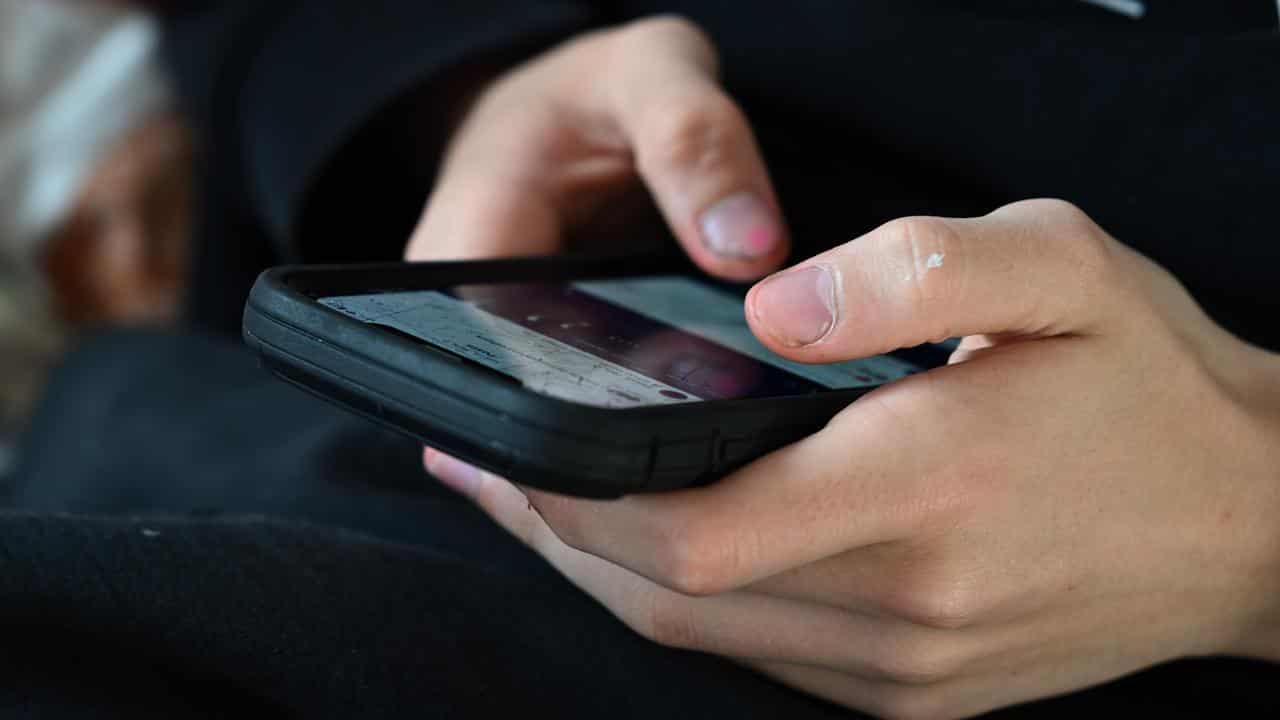 Teen uses mobile phone