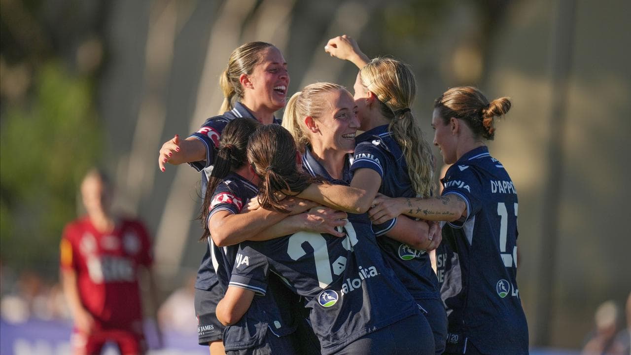 Melbourne Victory players celebrate.