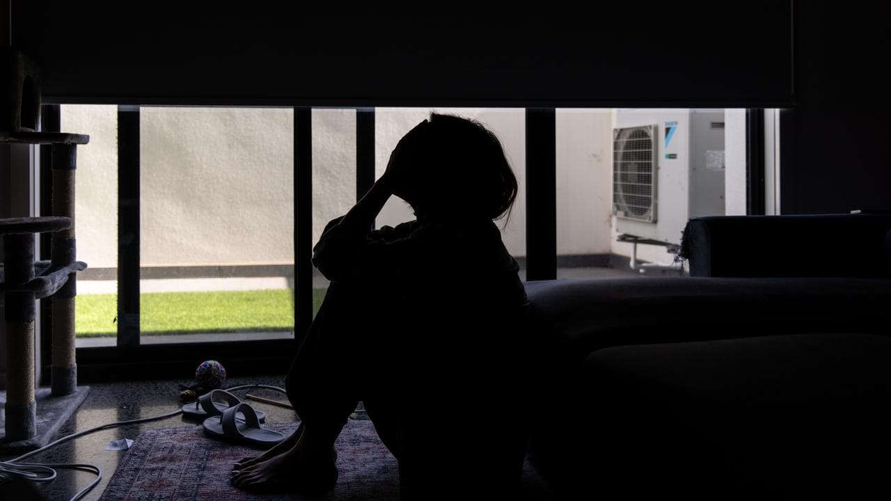 A distressed woman in the shadows