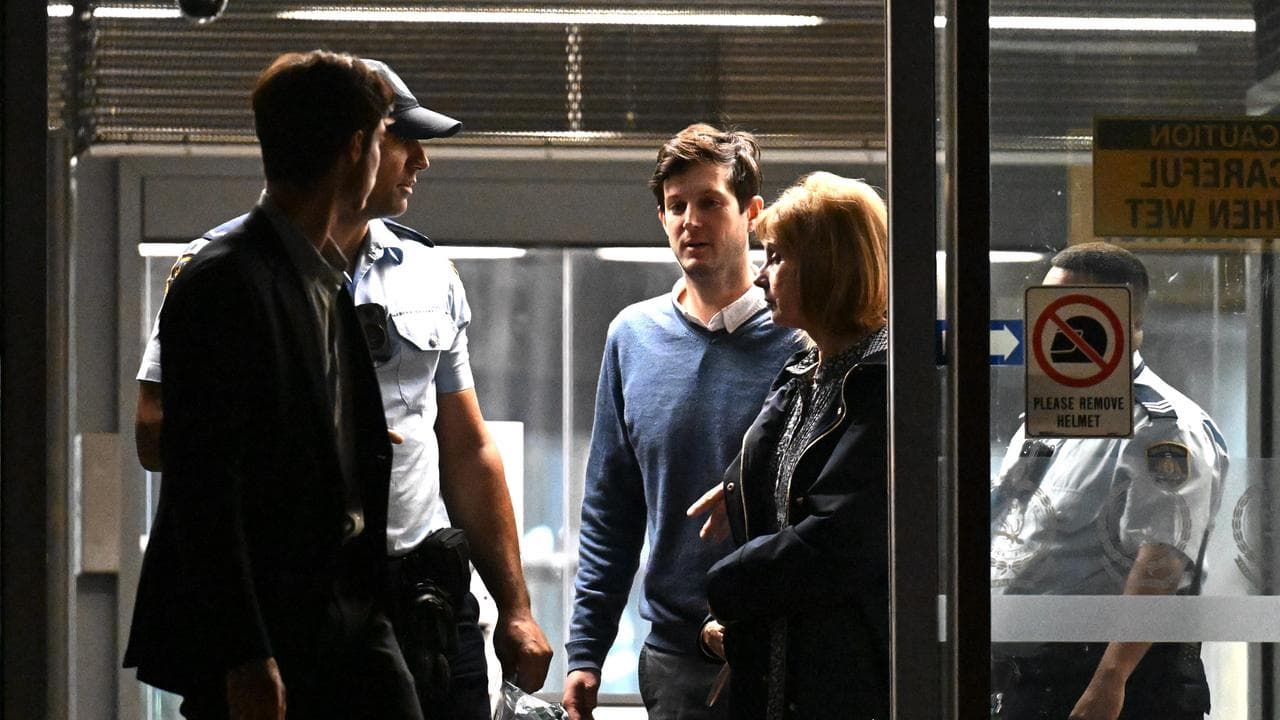 Rory Amon (centre) leaves Surry Hills Police Centre