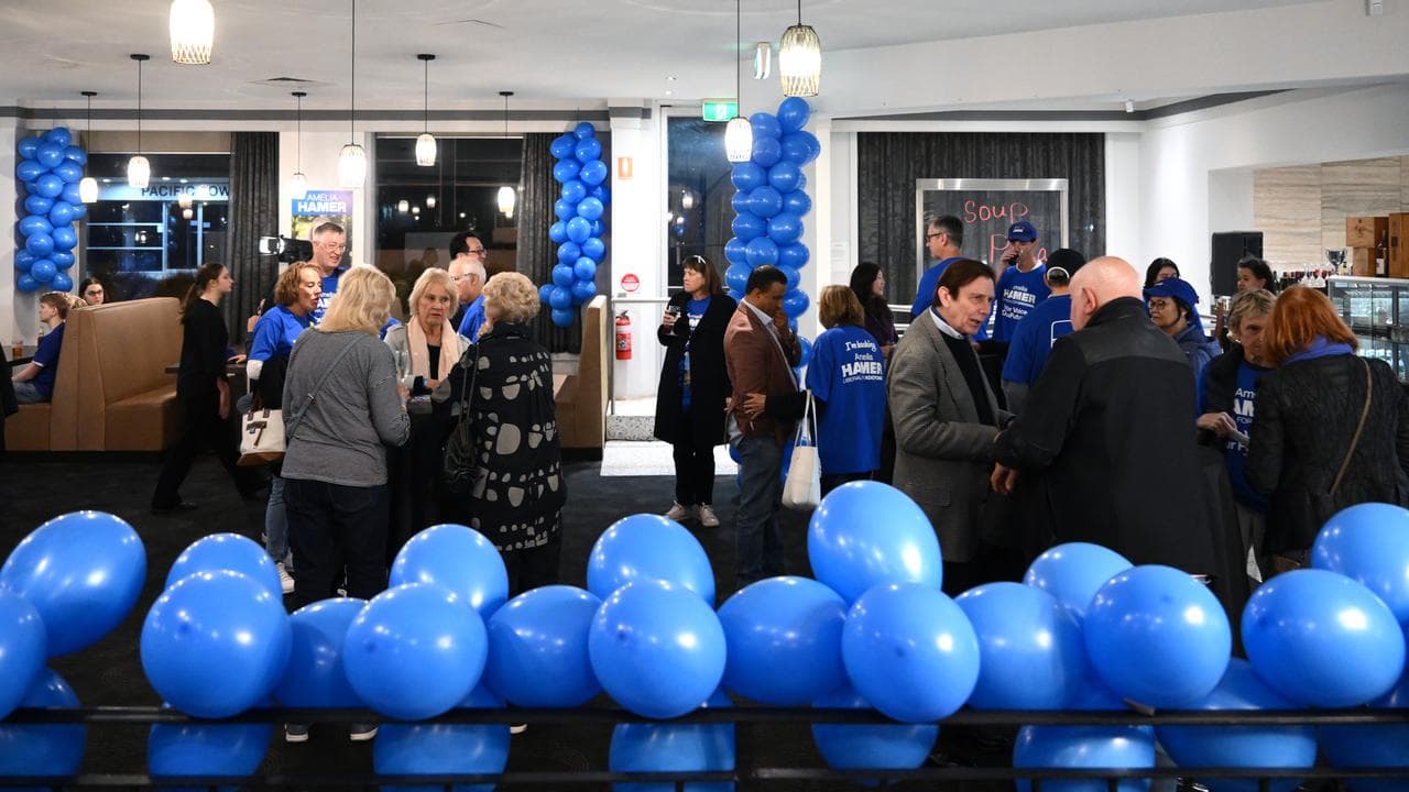 Liberal party function room with blue balloons.